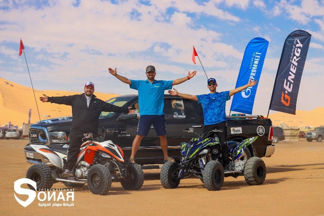 Off-road vehicles competing across the desert at the TT Rally in Waddan